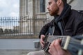 Closeup of a sad guitarist playing guitar alone. Cultural concept Royalty Free Stock Photo