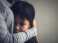 Closeup sad little boy being hugged by his mother at home. Royalty Free Stock Photo