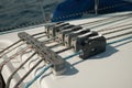 Closeup of a sailboat rope stopper on a white boat on the ocean