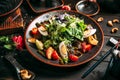 Closeup on salad with fresh vegetables, boiled eggs and beef on the black plate Royalty Free Stock Photo