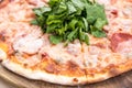 Closeup of salami pizza with ruccola, detailed. Royalty Free Stock Photo