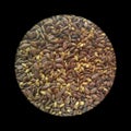 Closeup of salted flax seeds isolated from black round vignettes, food ingredients photography, healthcare