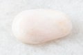 Polished Petalite rock on white marble Royalty Free Stock Photo