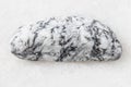 Tumbled Magnesite rock on white marble