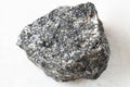 rough Nepheline Syenite rock on white marble Royalty Free Stock Photo