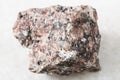 rough pink Granite rock on white marble