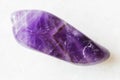 Tumbled Amethyst rock on white marble