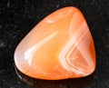 Tumbled Carnelian Cornelian rock on black Royalty Free Stock Photo