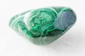 Tumbled Malachite rock on white marble Royalty Free Stock Photo