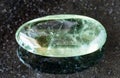 tumbled Prasiolite (green quartz) rock on black Royalty Free Stock Photo