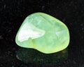 tumbled Prehnite rock on black Royalty Free Stock Photo