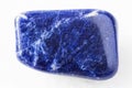 Tumbled Sodalite rock on white marble