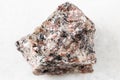unpolished pink Granite rock on white marble