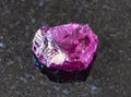 Unpolished Rhodolite pyrope crystal on black