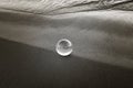 Closeup of sand and water on the beach with glass ball Royalty Free Stock Photo