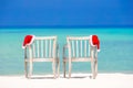 Closeup santa hat on chair on tropical white beach Royalty Free Stock Photo