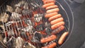 Closeup of sausage on the grill. Sausages are grilled BBQ. Grilled sausage on the flaming grill Royalty Free Stock Photo