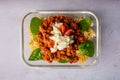 Closeup of a savory mixture of noodles and diced meat on the transparent plate