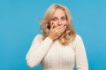 Closeup scared shocked blond woman closing mouth with hand, afraid to say too much, embarrassment Royalty Free Stock Photo
