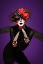 A closeup of a scarier clown female Holding Knife Royalty Free Stock Photo