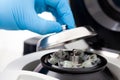 Closeup of a scientist closing an small table centrifuge filled with tubes. Spin column-based nucleic acid purification technique