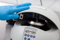 Closeup of a scientist closing an small table centrifuge filled with tubes. Spin column-based nucleic acid purification technique