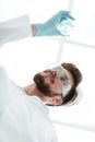 Closeup.scientist holding beaker with the sample