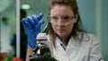 Closeup of scientist woman looking at test sample of lea