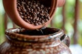 closeup of a scoop of coffee beans being transferred to a ceramic jar Royalty Free Stock Photo