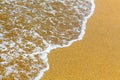 Closeup of sea foam on wet golden sand with copy space Royalty Free Stock Photo