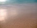 Closeup of sea sand detail texture with gradation of green ocean background. Selected focus