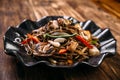 Seafood soba noodles wok in a black plate Royalty Free Stock Photo