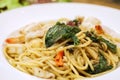 Closeup seafood stir fried spicy spaghetti in white ceramic plate