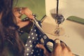 Closeup of seamstress cutting material with scissors