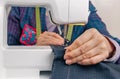 Seamstress hands working on a sewing machine