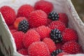 Closeup of red balloon berries or strawberry raspberry and blackberries