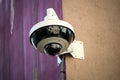 Security camera on stoned wal in the street Royalty Free Stock Photo