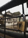 Closeup selective focus of love padlock symbol on bridge railing in Strasbourg Grand Est Alsace France on a rainy day