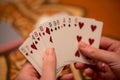 Closeup selective focus shot of a hand holding a hand of playing cards Royalty Free Stock Photo