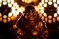 Closeup selective focus shot of a little golden monk statue illuminated by warm candlelight Royalty Free Stock Photo