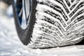 Closeup selective focus on snow packed in an all-weather tire tread. Royalty Free Stock Photo