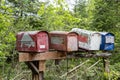 Old rusting mail boxes on wooden post Royalty Free Stock Photo