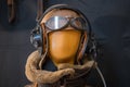 Closeup selective shot of a mannequin head with aviator hat, goggles and headphones