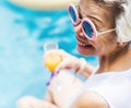 Closeup of senior asian woman with juice by the pool