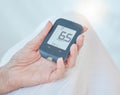 Closeup of a senior diabetic woman checking her blood sugar glucose levels with a diabetes reading strips machine. One Royalty Free Stock Photo