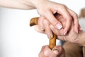 Closeup of senior mans hands and young girl caregiver holding hands on walking stick Royalty Free Stock Photo