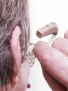 Closeup senior woman using hearing aid