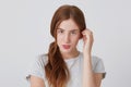 Closeup of sensual beautiful young woman with red hair and freckles standing and looking directly in camera isolated over white Royalty Free Stock Photo