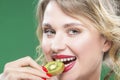 Fruit Kiwi Series. Closeup of Sensual and Naked Caucasian Model with Teeth Diastema Posing With Juicy Kiwi Fruit. Against Gr Royalty Free Stock Photo