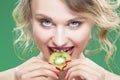 Fruit Kiwi Series. Closeup of Sensual and Naked Caucasian Model with Teeth Diastema Posing With Juicy Kiwi Fruit. Against Gr Royalty Free Stock Photo